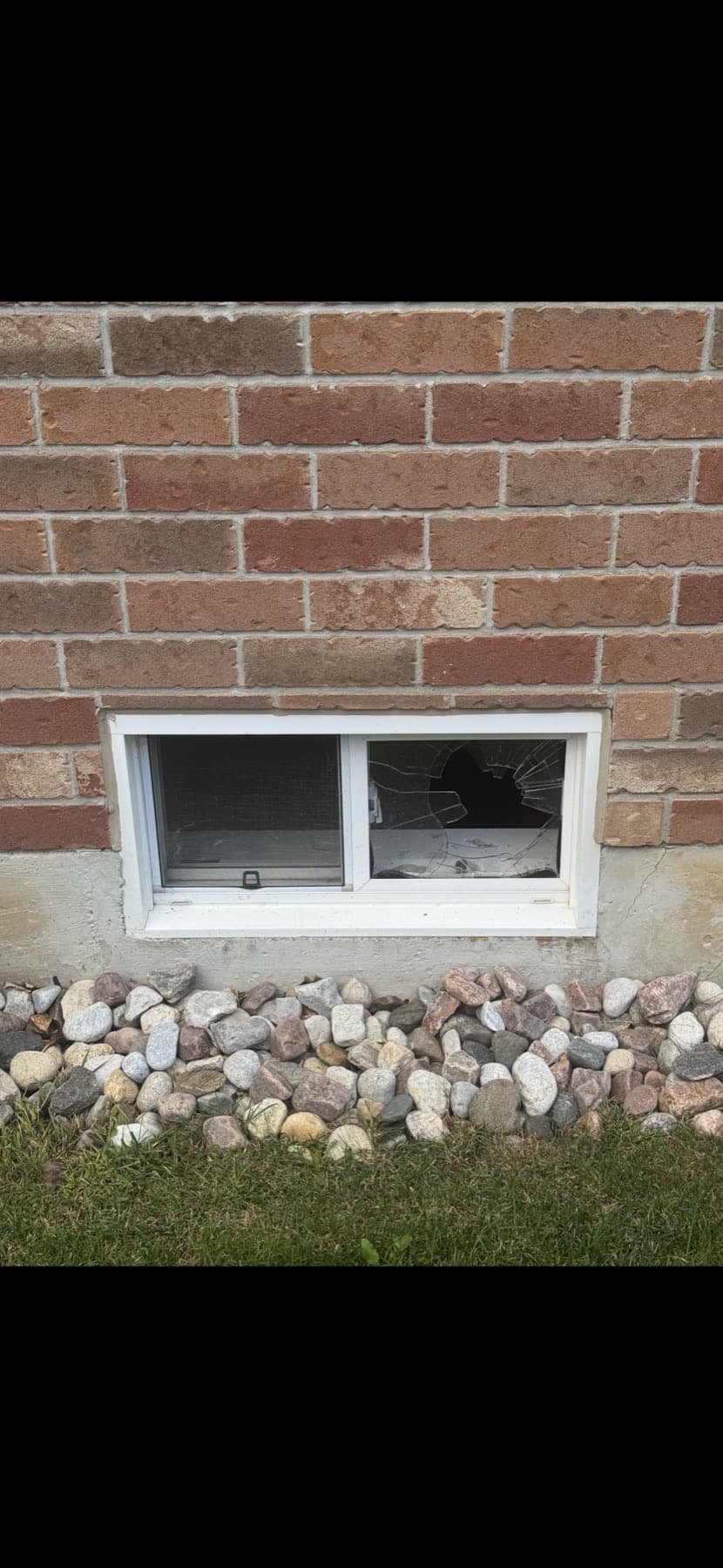 Broken basement window before the glass replacement