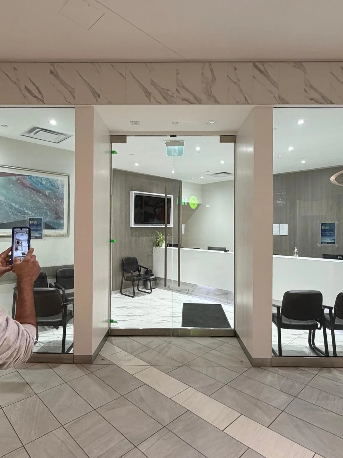 Commercial entrance with full-height glass and stainless pull handles