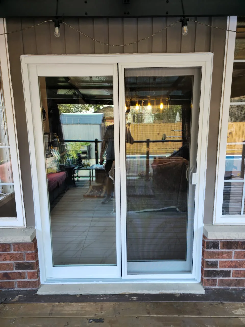 White sliding patio door and screen photographed from outside