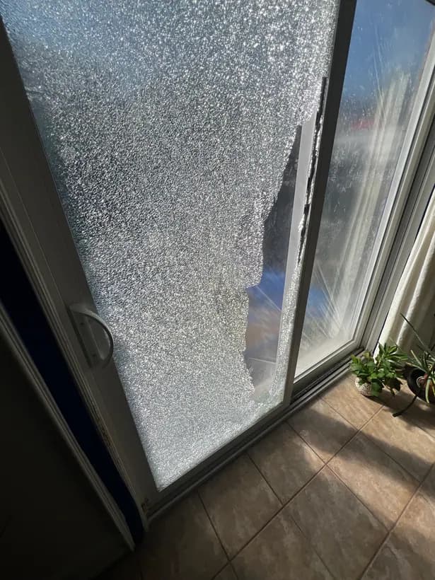 Shattered glass in a sliding patio door, photographed by the customer.